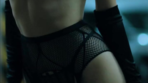 A model with an hourglass figure in long boots, stockings and black gloves seduces me in the parking