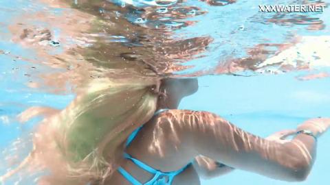 Golden goddess Lisi dives into wet poolside paradise, sultry nakedness exposed