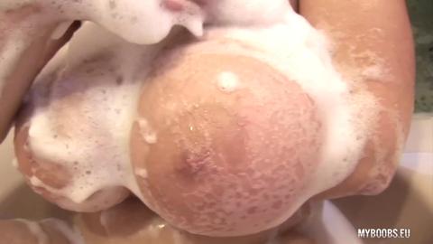 Naughty😈 TerryNova milks massive melons in suds-filled tub, self-pleasuring on camera.